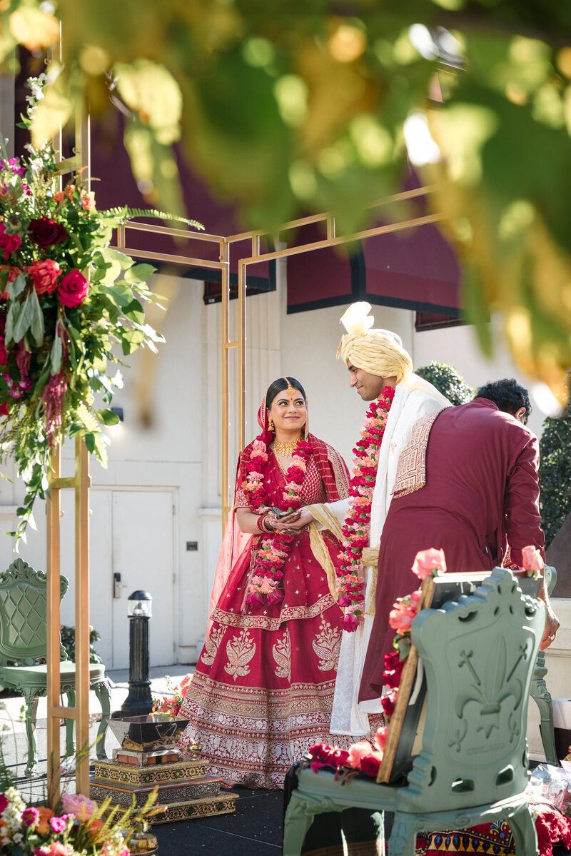 Indian bride and groom exchanging vows during traditional wedding ceremony at the Grand Bohemian Hotel Charlotte, captured by a professional Indian wedding photographer in Charlotte.