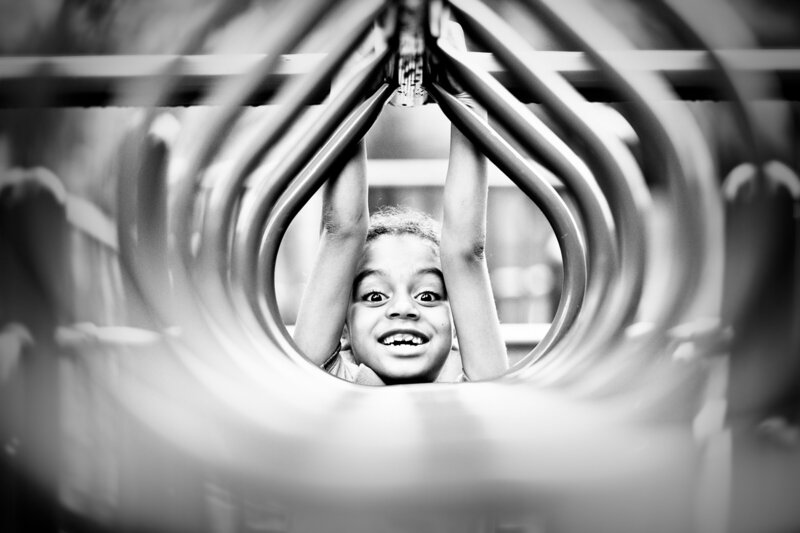 Young child gleefully playing on a playground
