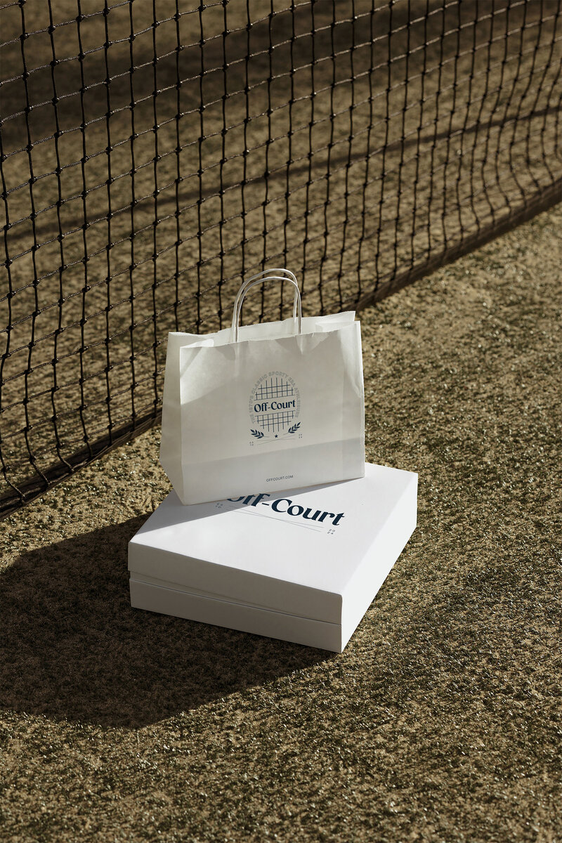 Athena brand identity with minimalist business card design for interior design studio, styled on neutral textured fabric.