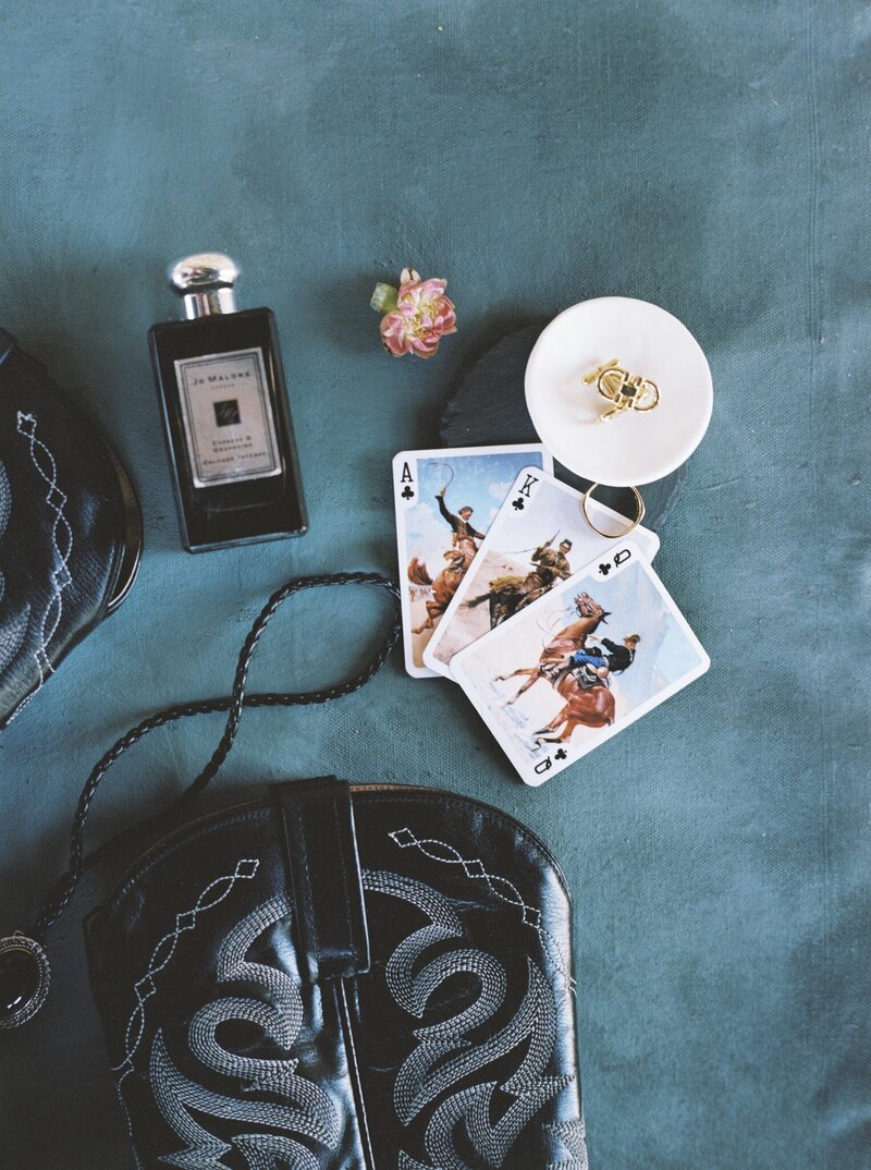 flatlay with playing cards and perfume bottle