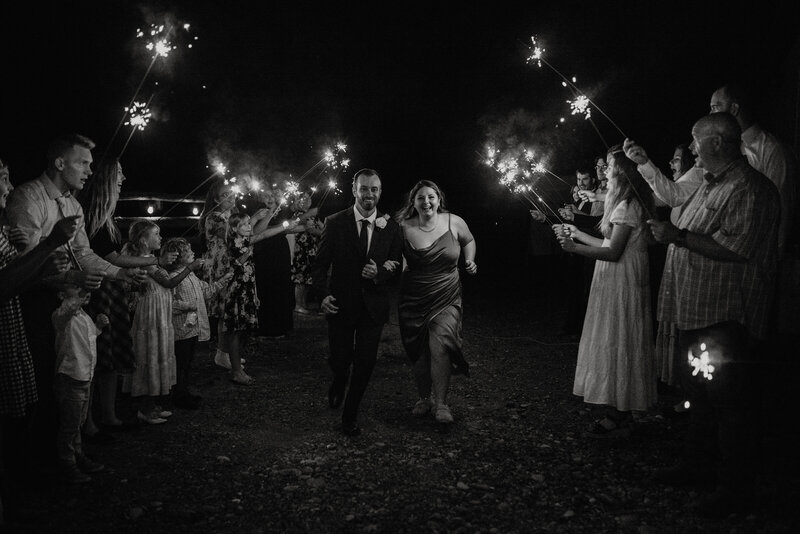 ecstatic couple running down the isle at their Wyoming wedding