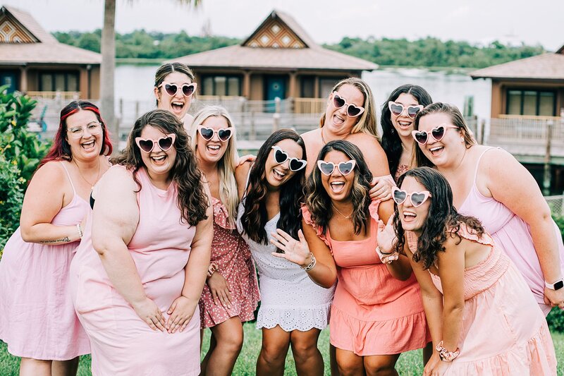 Girls trip at Disney's Polynesian Resort, heart sunglasses and matching outfits for bachelorette party