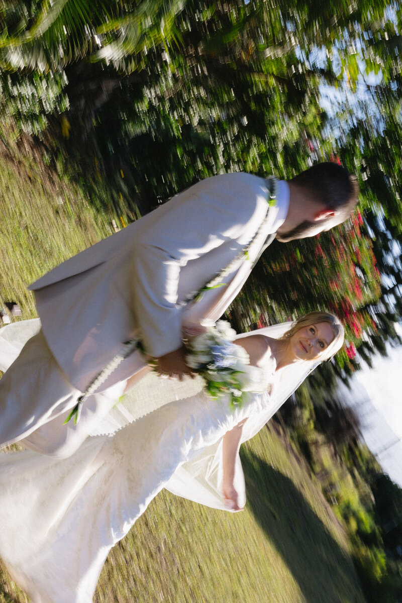 Traditional Hawaiian officiant blessing the couple with conch shell