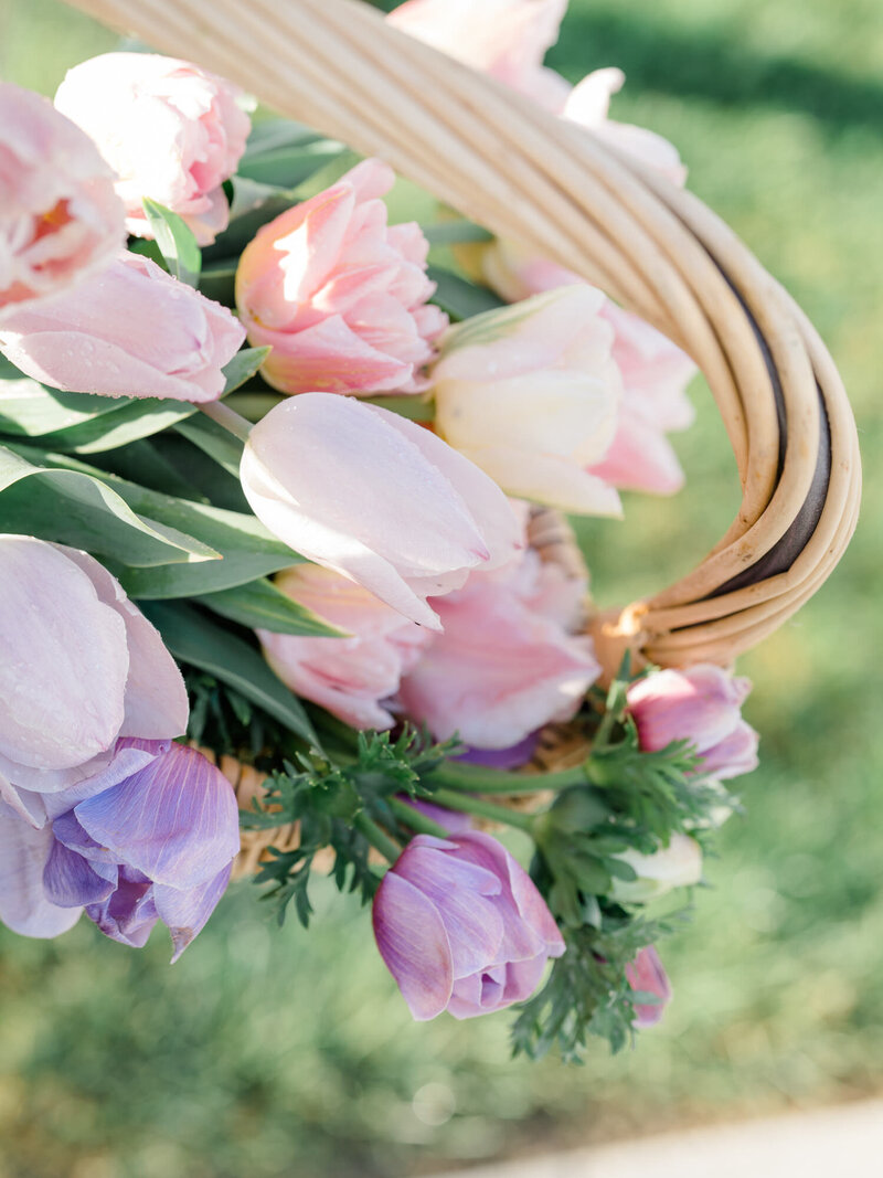 pink and purple tulips in a wicker basket