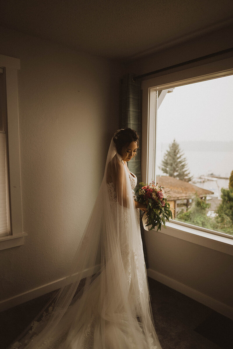seattle elopement gallery photo of bride looking down at her dress during her seattle elopement