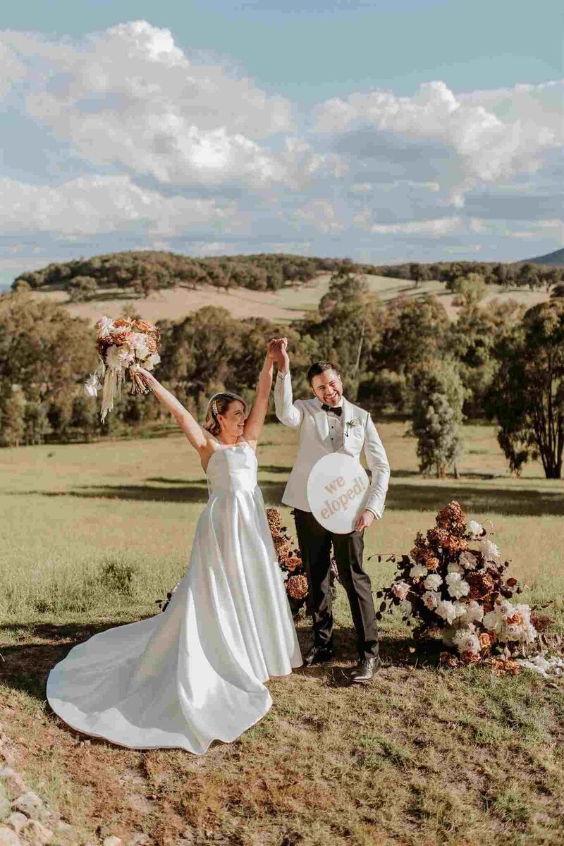 Bride and groom hugging each other.