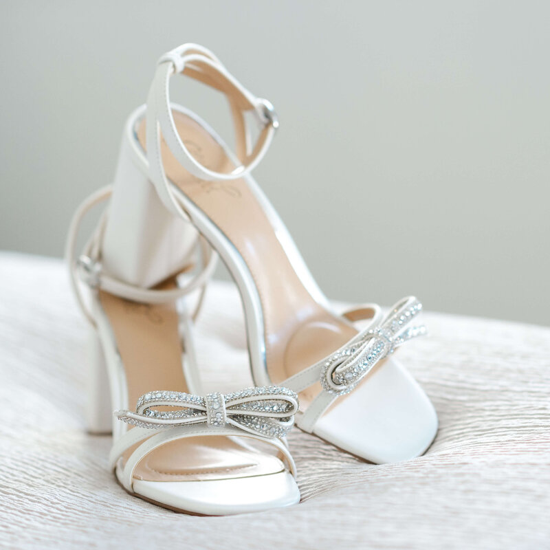 a closeup photo of a bride's shoes on  her bed captured by Ottawa wedding photographer JEMMAN Photography