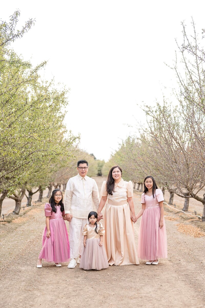 Family holding hands during Christmas mini session with Gia Chong Photography