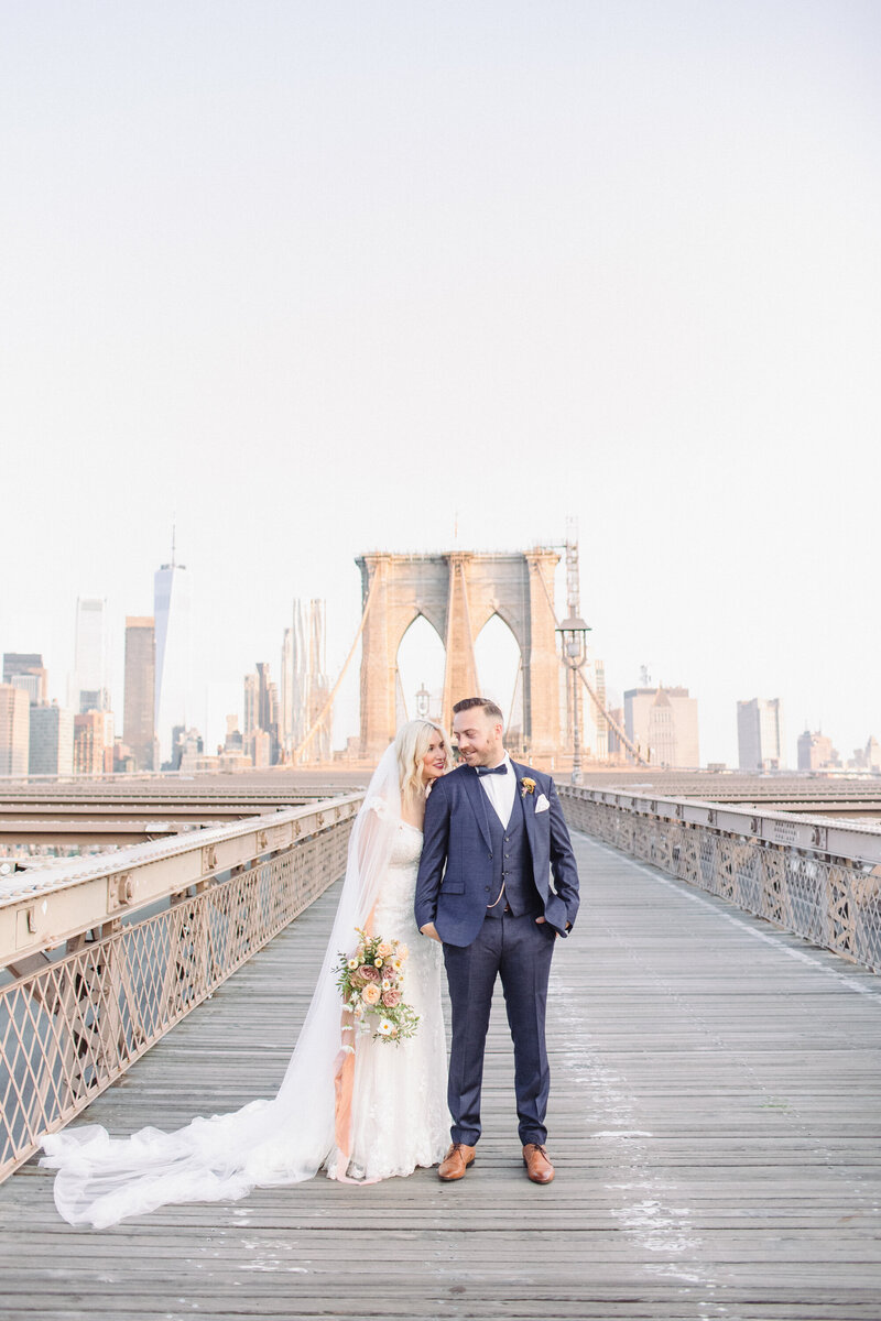Bride and groom on Brooklyn Bridge in NYC