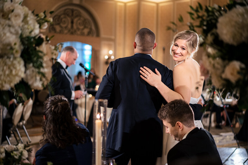 bride and groom standing under chuppah while exchanging vows