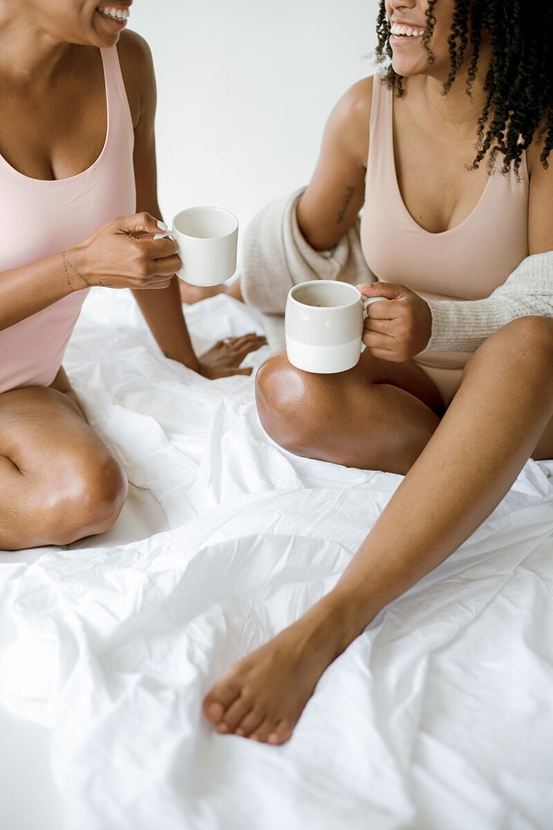 an image of two black women on a website for group motherhood coaching program for moms of color