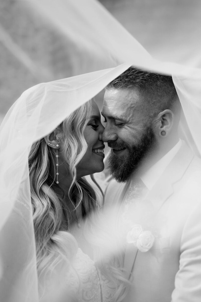 Bride and groom sharing a tender moment under the veil during their wedding in Doylestown, Pennsylvania