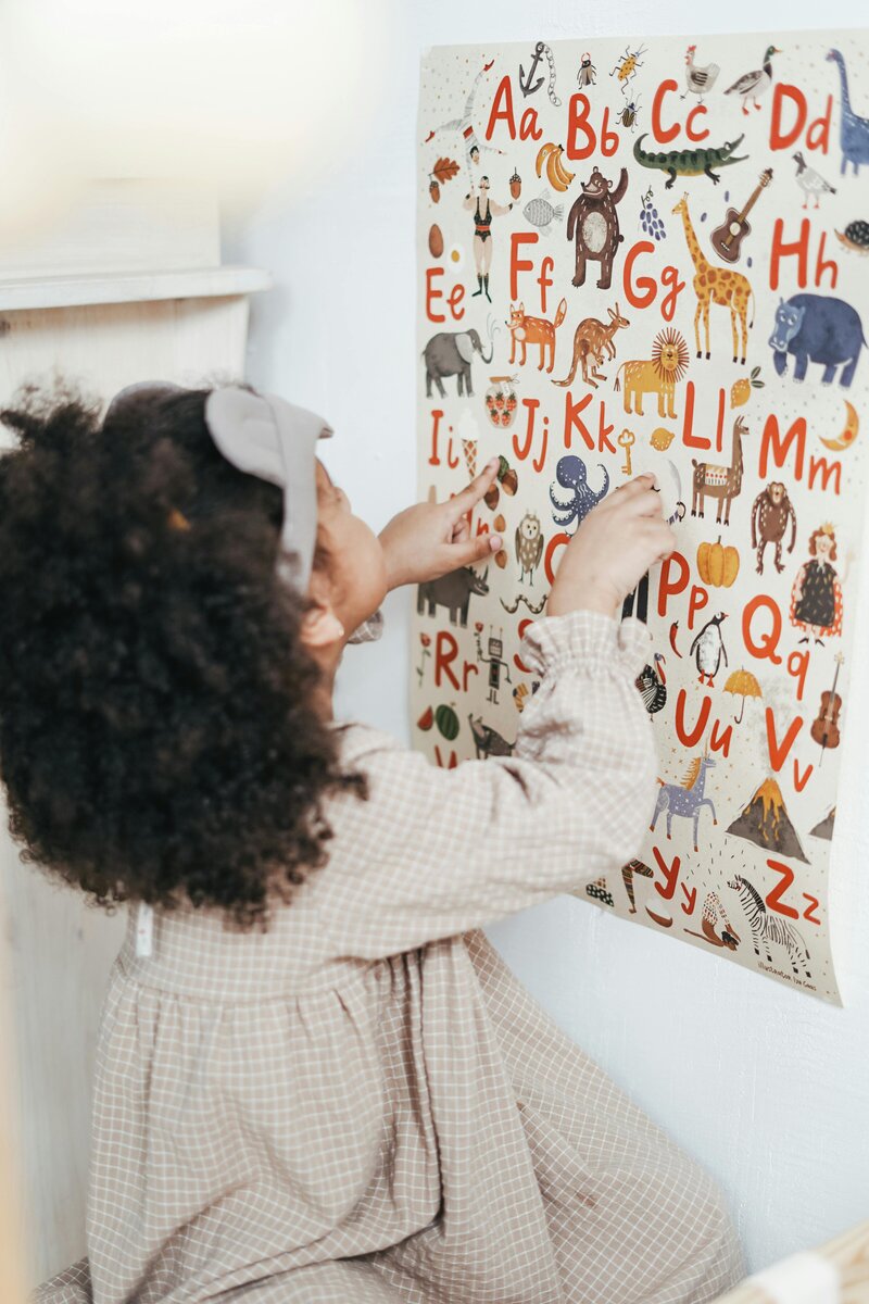 A child engaging in a hands-on literacy activity using letter tiles, promoting phonemic awareness and decoding skills.