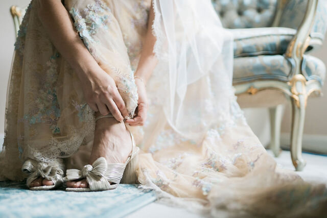bride putting on her loeffler randlall bridal shoes