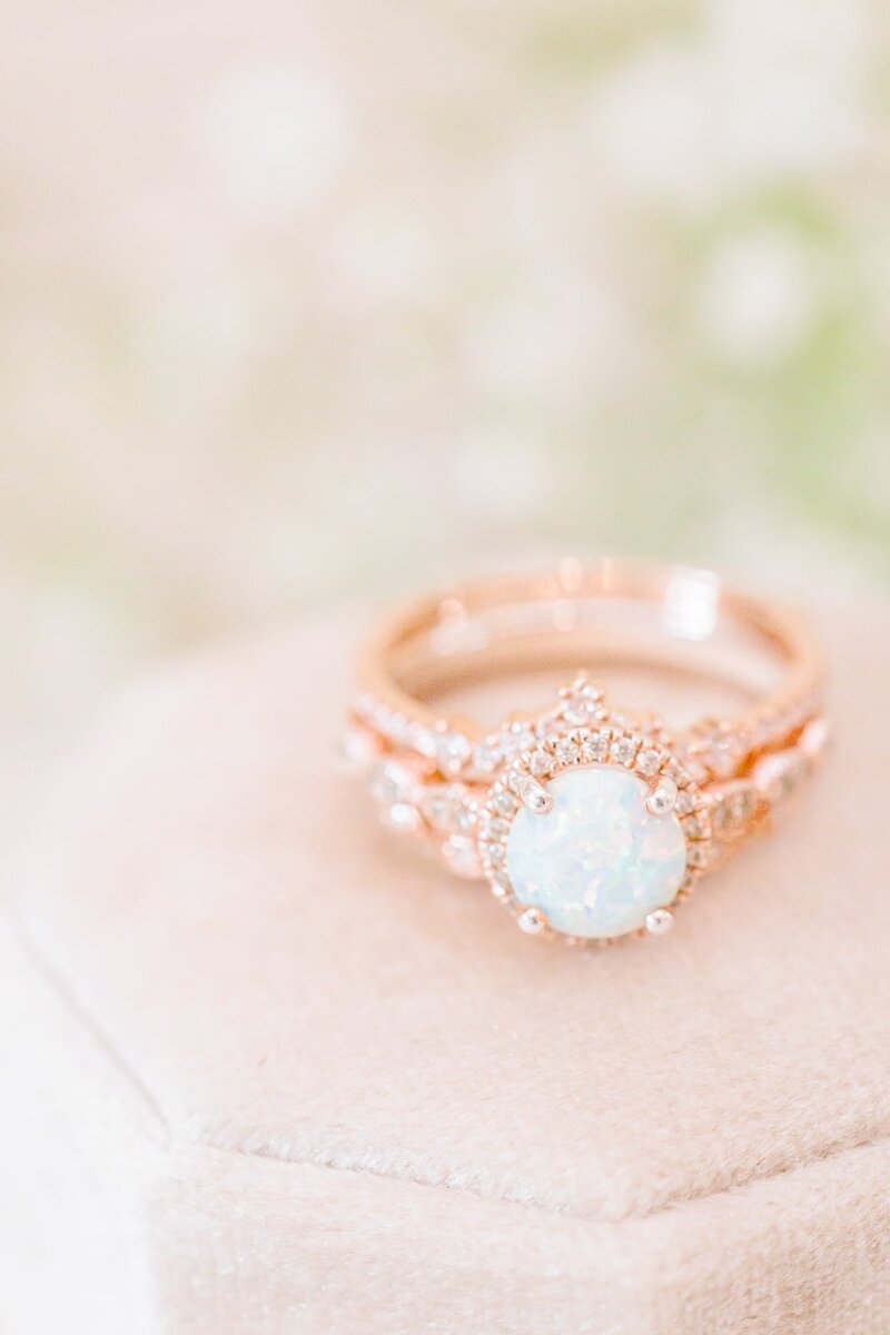 A rose gold engagement ring with an opal center stone.