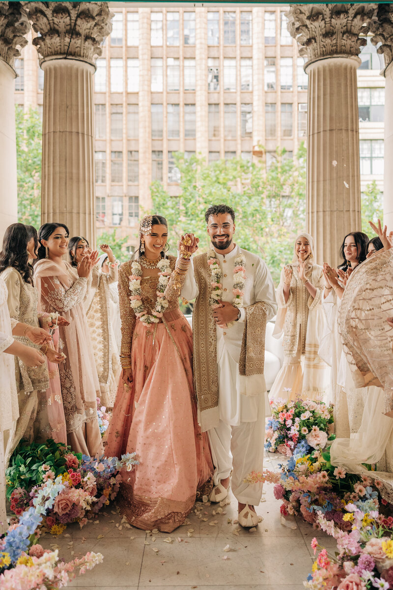 a bride and groom looking at each other with the melbourne city skyline in the back ground