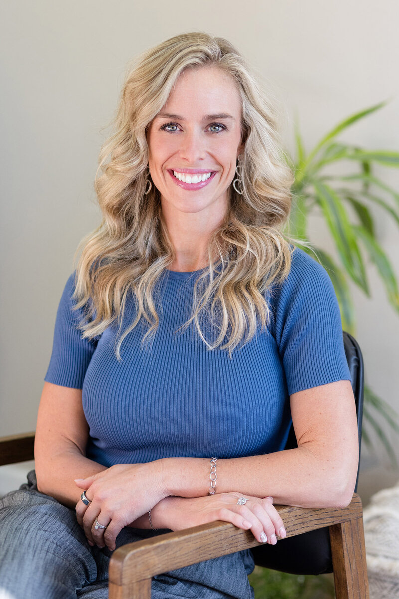 Jamie sitting in a chair smiling