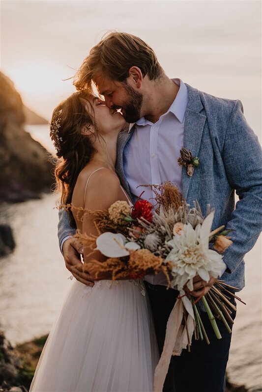 Couple kissing at their beach wedding in Italy