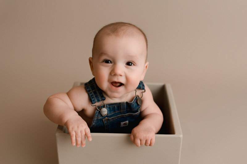 Baby milestone session baby smiling in studio Ohio