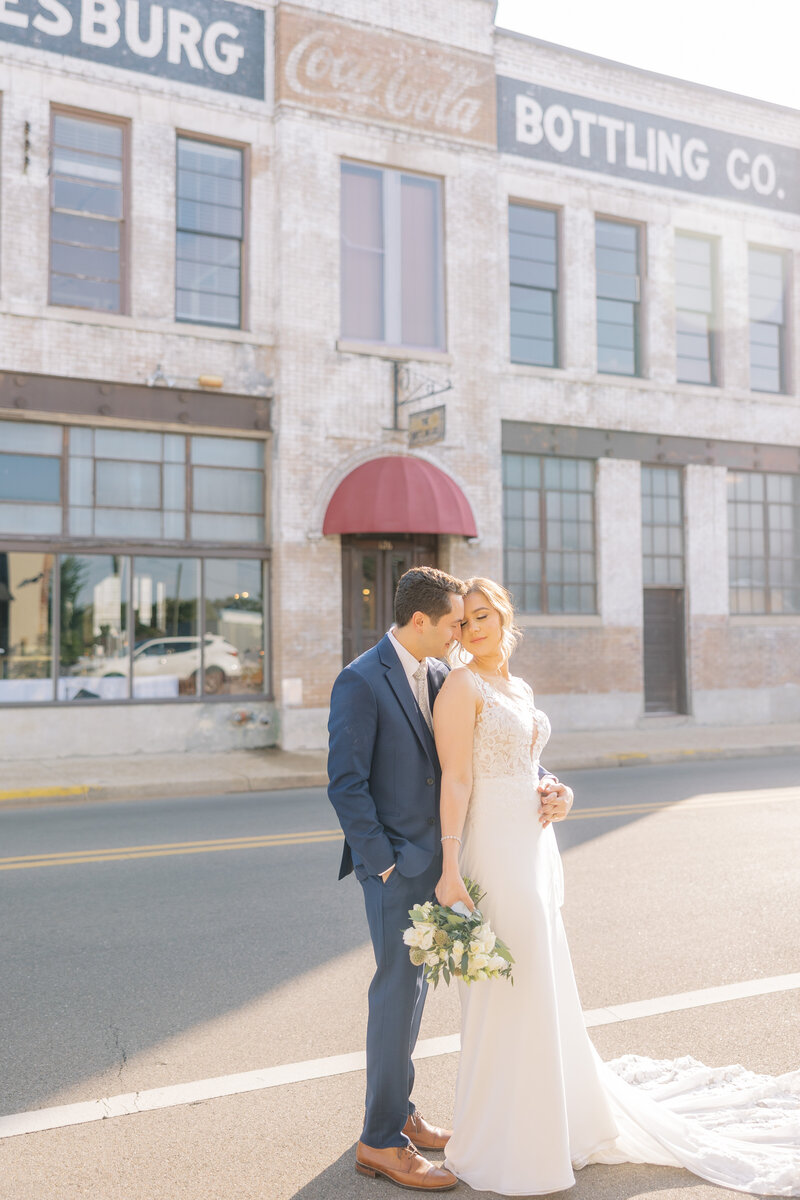 bride and groom holding hands in a downtown district