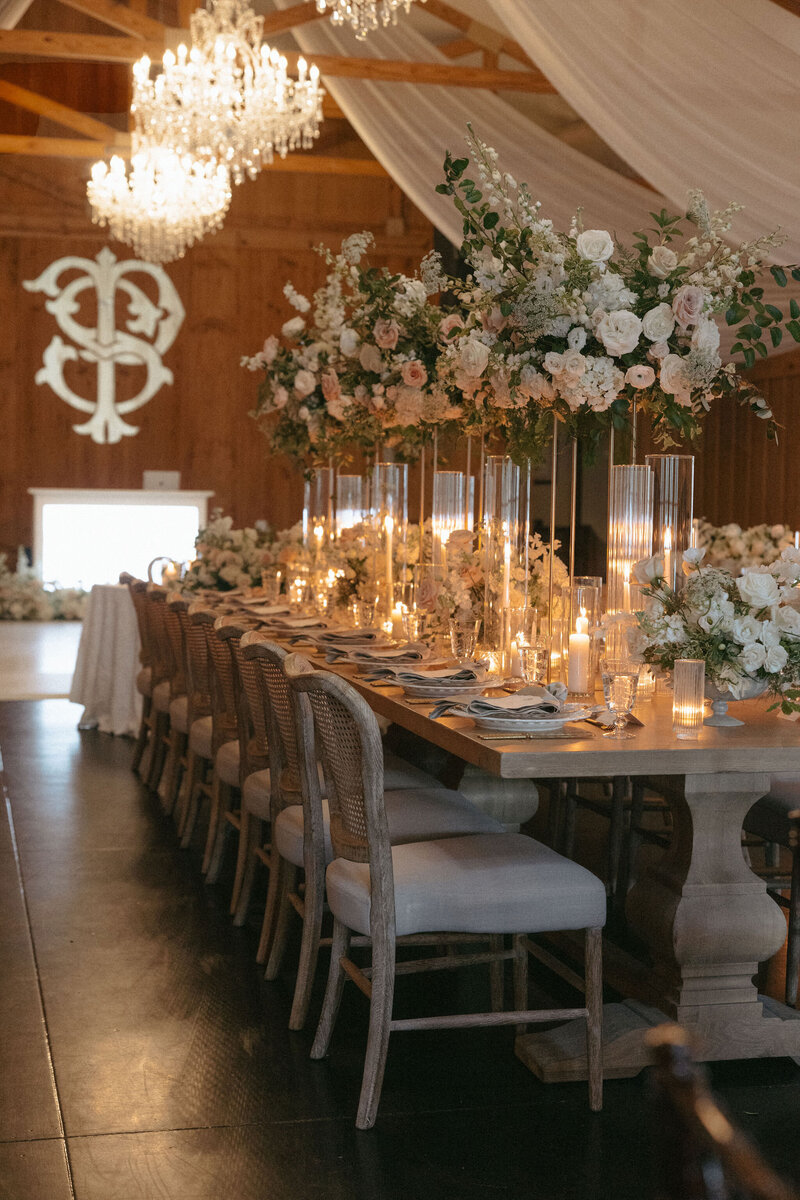 Elegant luxury floral centerpieces with neutral blooms. Elegant roses, with mixed greenery. highlighting refined wedding design by The Eventful Gals.