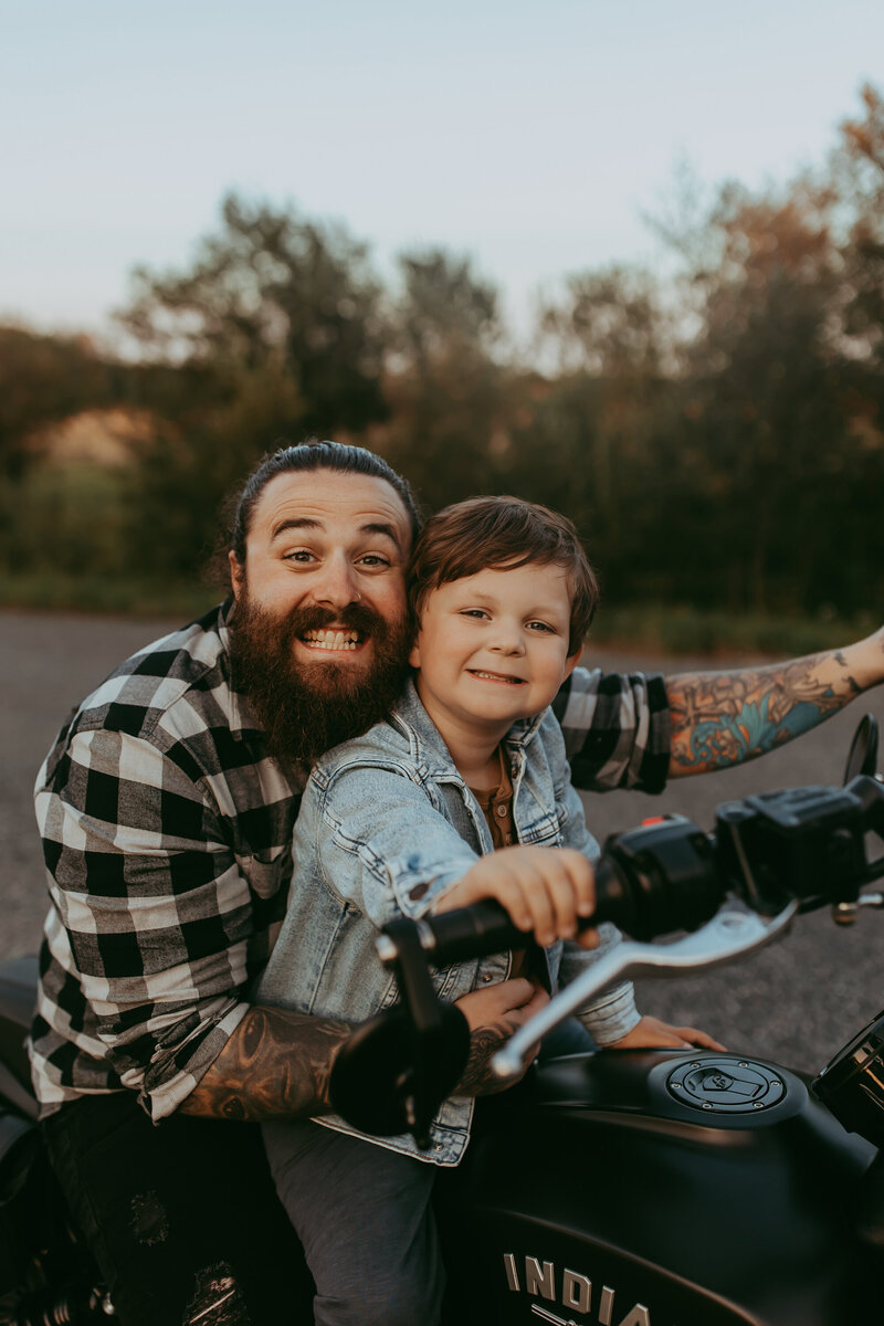 father-son-smiling-on-bike