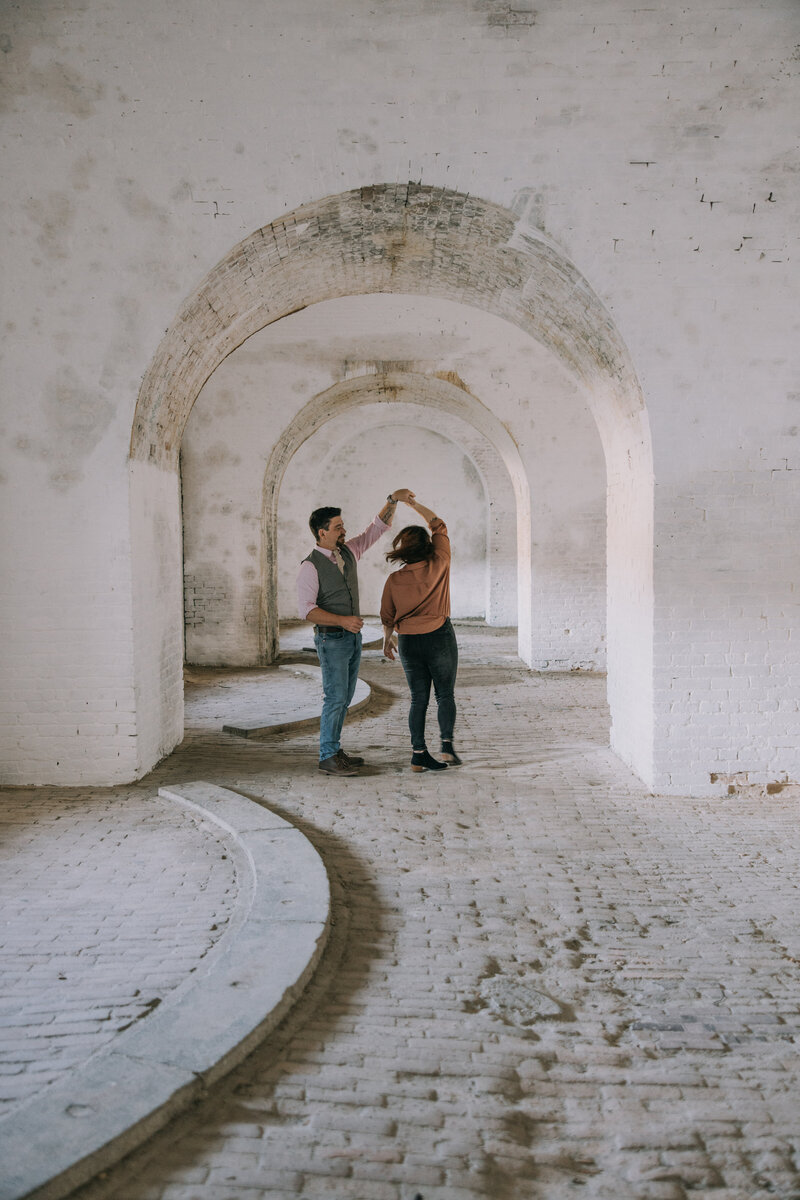 Couple during their engagement photo session at Fort Pickens on Pensacola Beach in Florida.