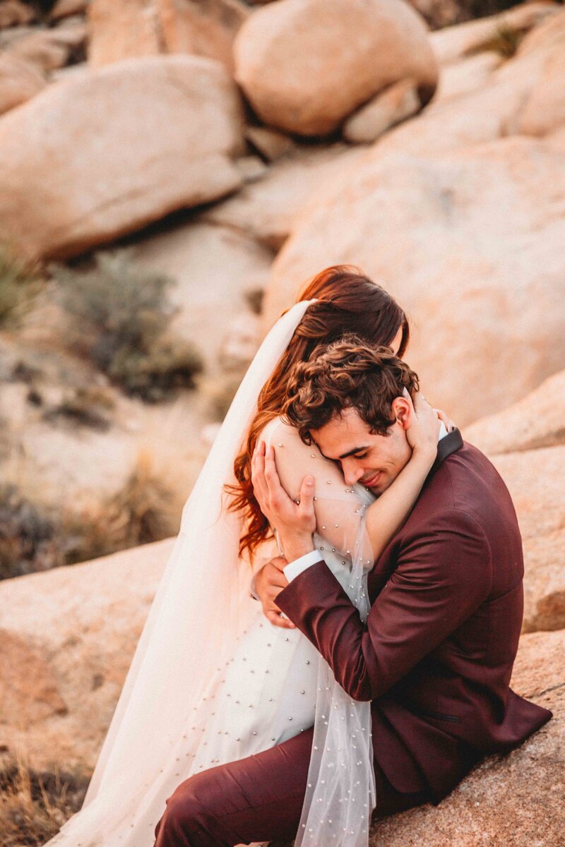 Couple embracing after elopement in joshua tree california