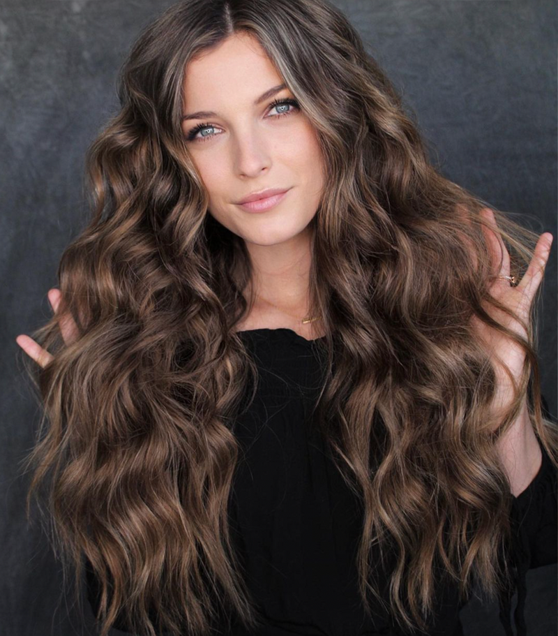 Dimensional brunette hair extension model posing