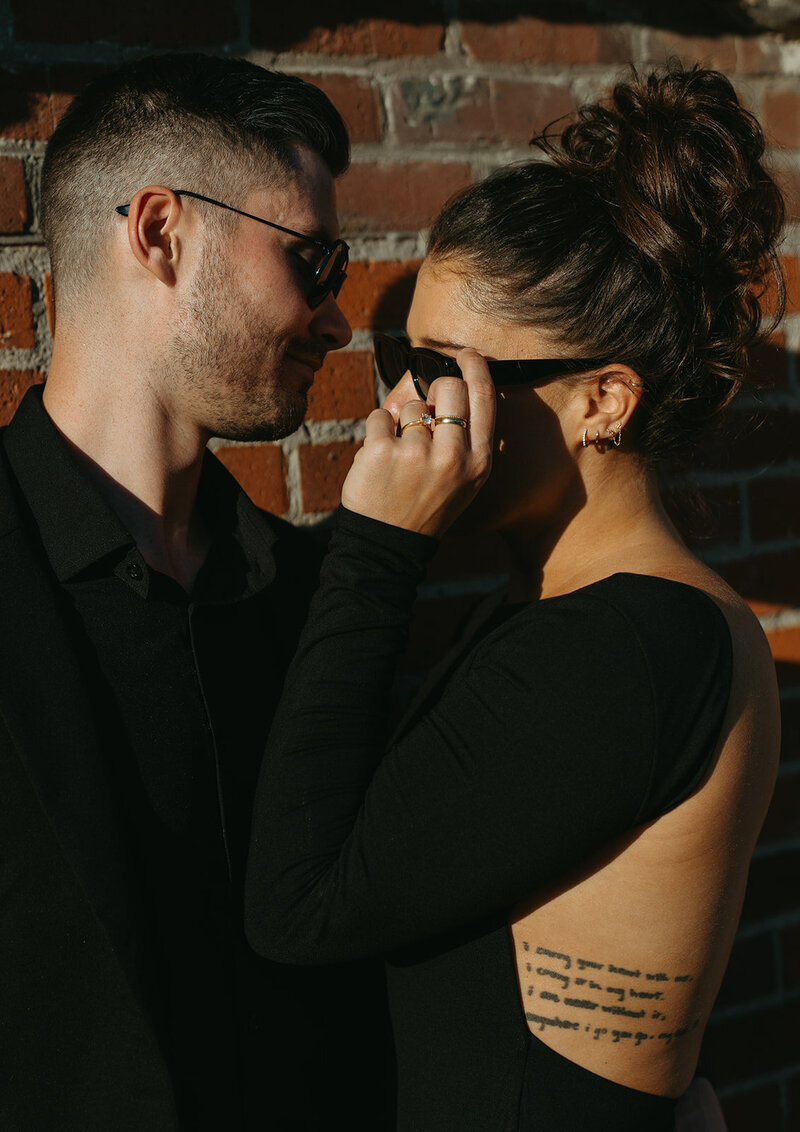 couple wearing all black and sunglasses