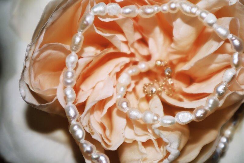 Artistic image of jewelry and flower from Luxury Photographer at ADP Studio