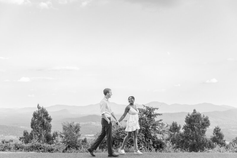 Couple walking and holding hands over the Shenandoah mountains