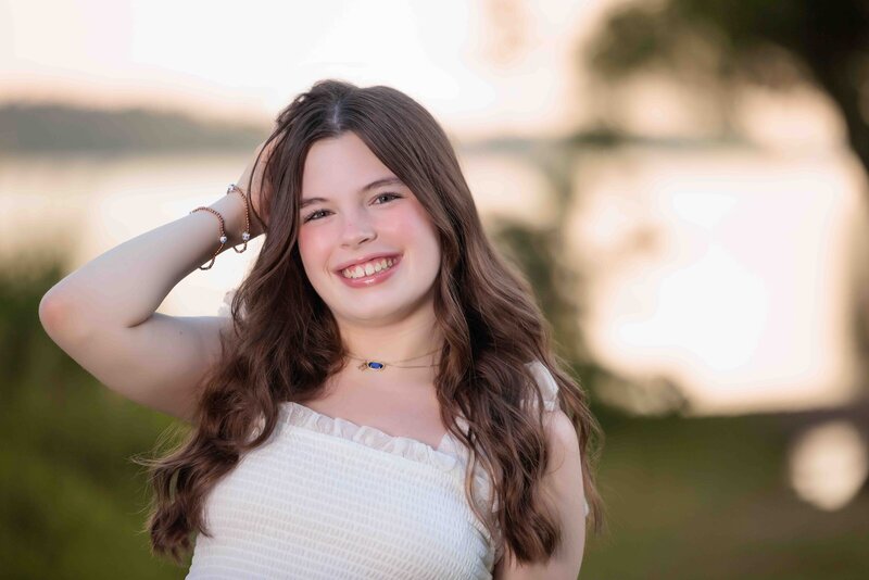 Lake Raleigh Teen Portraits sitting on the rocks by the water.