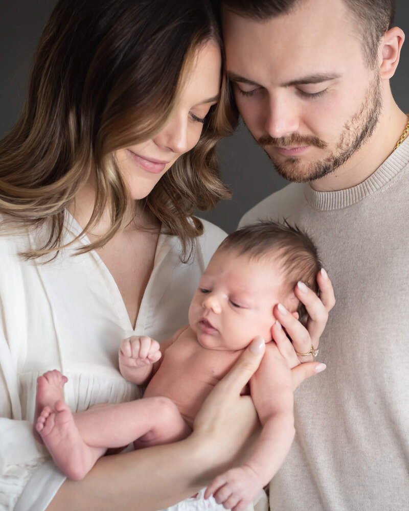 studio  family session closeup of mom dad and new baby