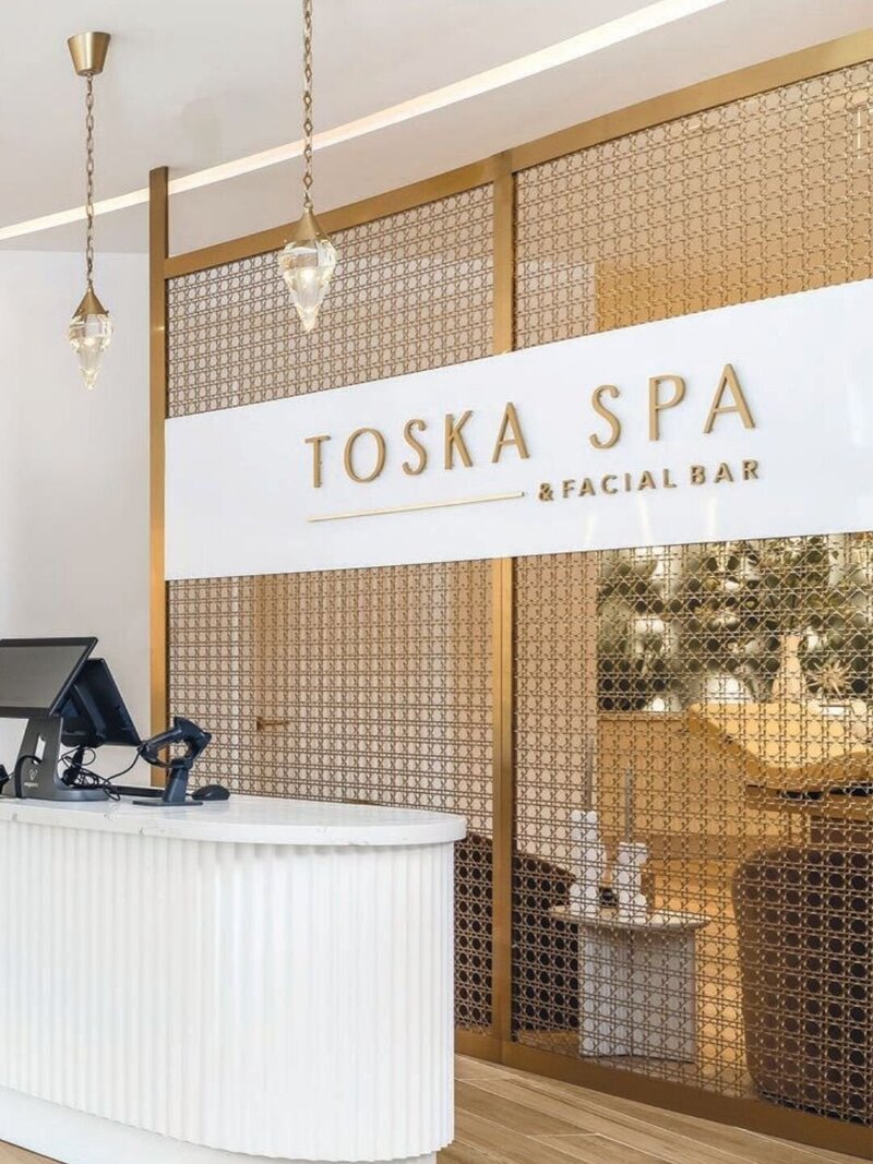 Interior brand signage at Toska Spa’s Miami location, continuing the refined visual identity