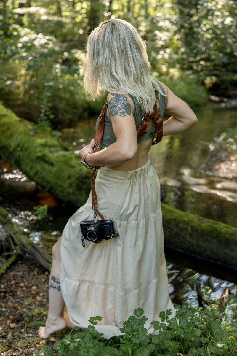 photographer in woods holding film and digital canon cameras canon A1