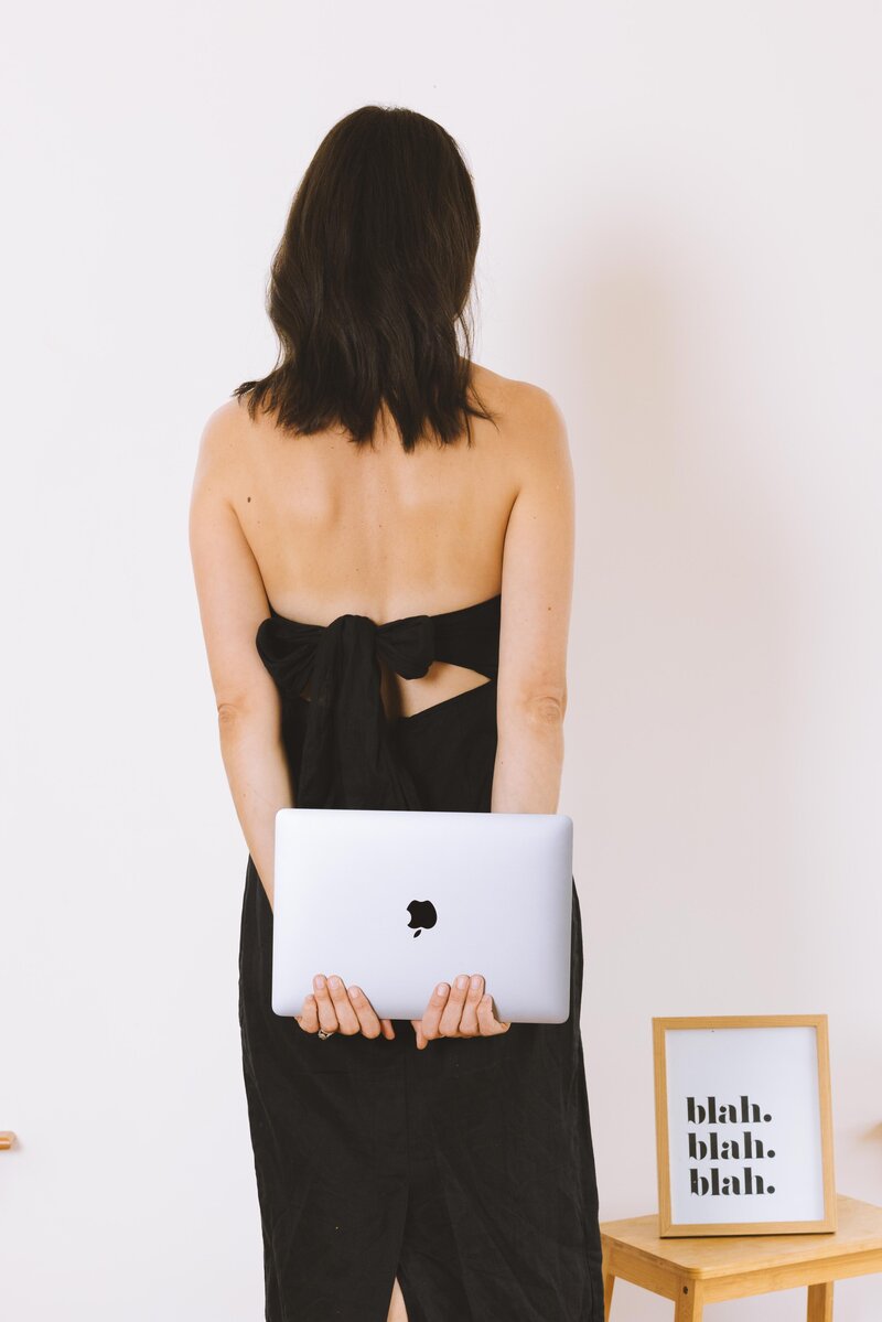 dirty copy stands with laptop copywriting course behind back