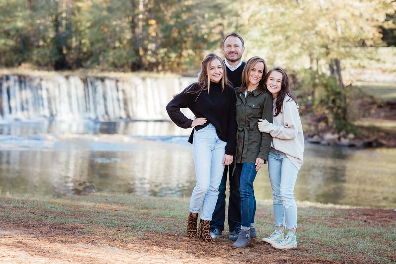Family portraits taken in front of the waterfall at Starrs Mill in Fayetteville Georgia