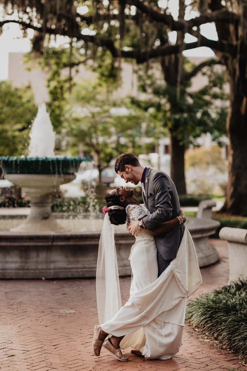 Couple standing in front of water fountain in downtown Savannah