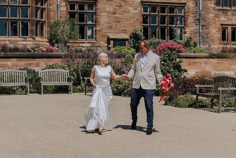 Bride and groom holding hands in the gardens of Salt House at golden hour, captured by Nostalgia by Sophie Louise