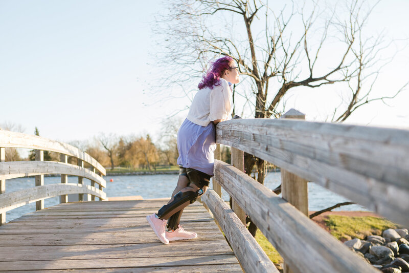 A woman relaxing on a bridge, supported by custom orthotics from Lethbridge Orthotics, offering exceptional comfort, strength, and flexibility.