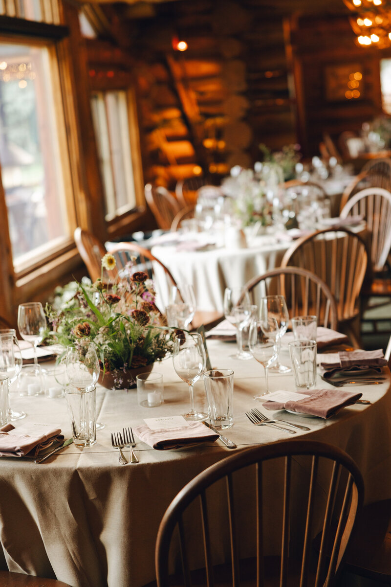 wedding reception tables set with dinnerware and flowers