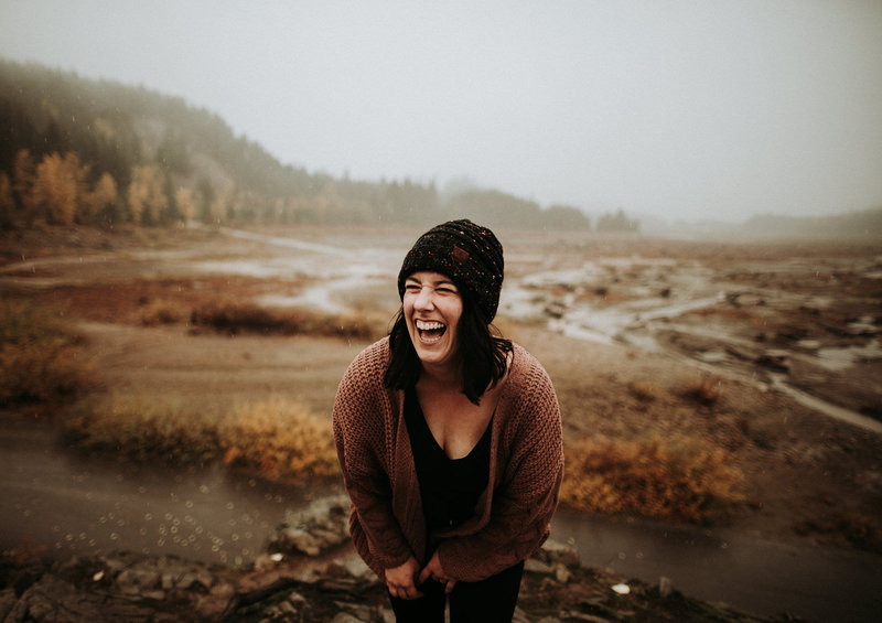A photographer laughs in the rain.