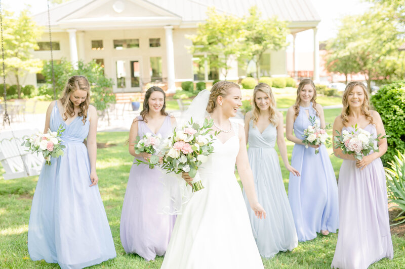 A bride and her bridesmaids walk the gardens of Whitehall Manor with Northern Virginia Wedding Photographer