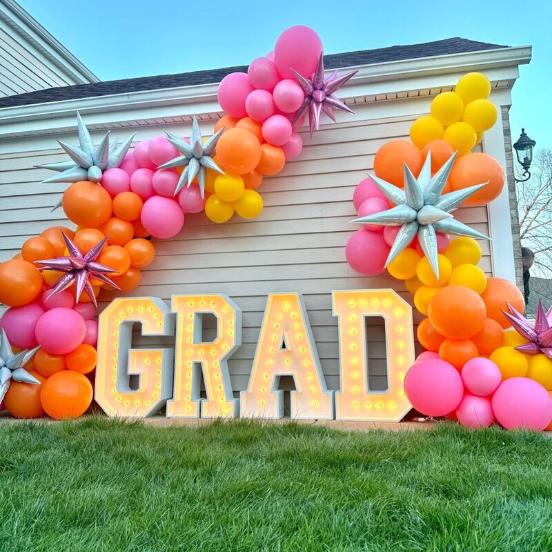 pink, yellow, orange graduation balloons and marquee letters in Chicago