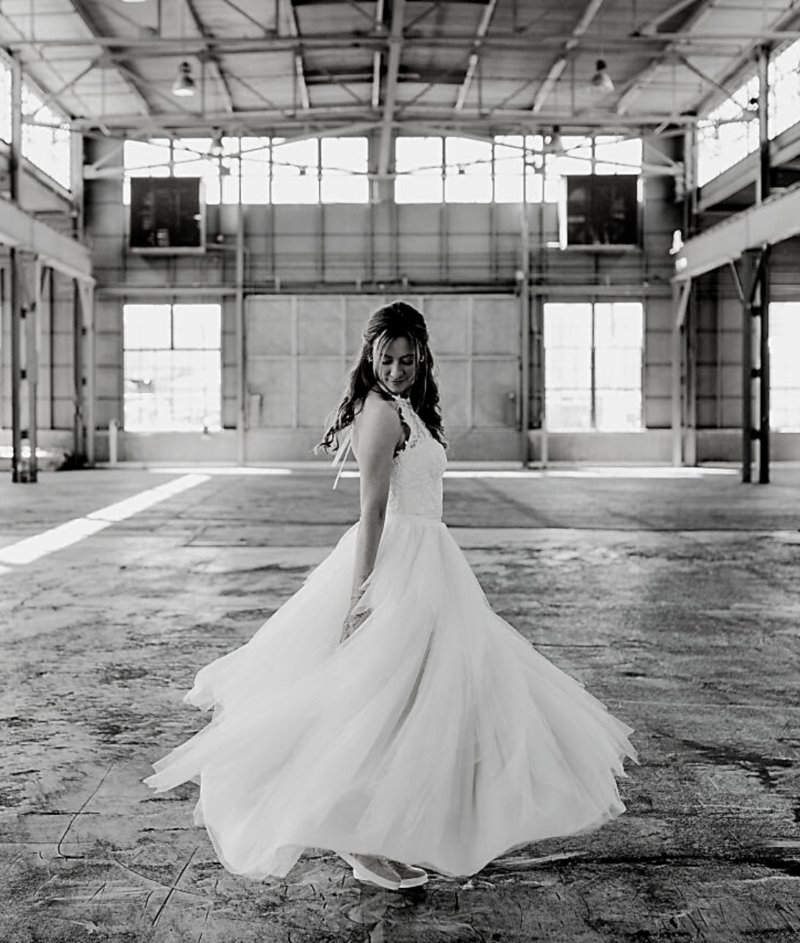 bride twirling in warehouse