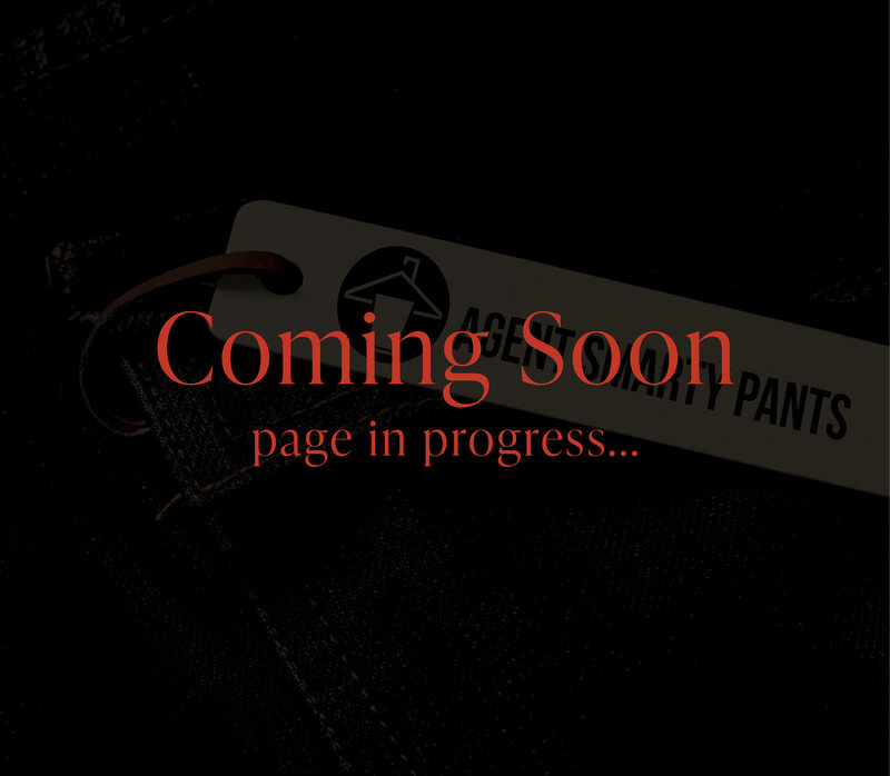 Agent Smarty Pants logo displayed on a clothing tag over dark denim, showcasing a bold and playful brand identity.