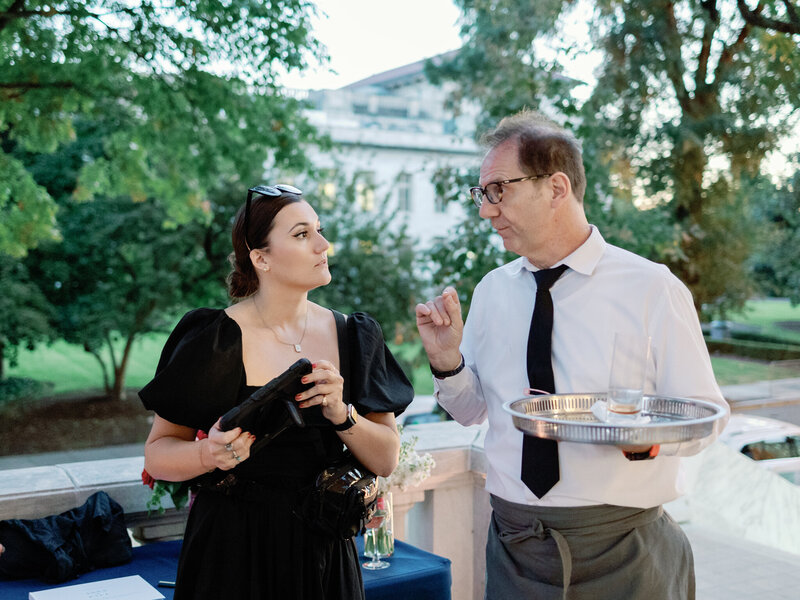 Wedding planner talks with caterer at wedding reception