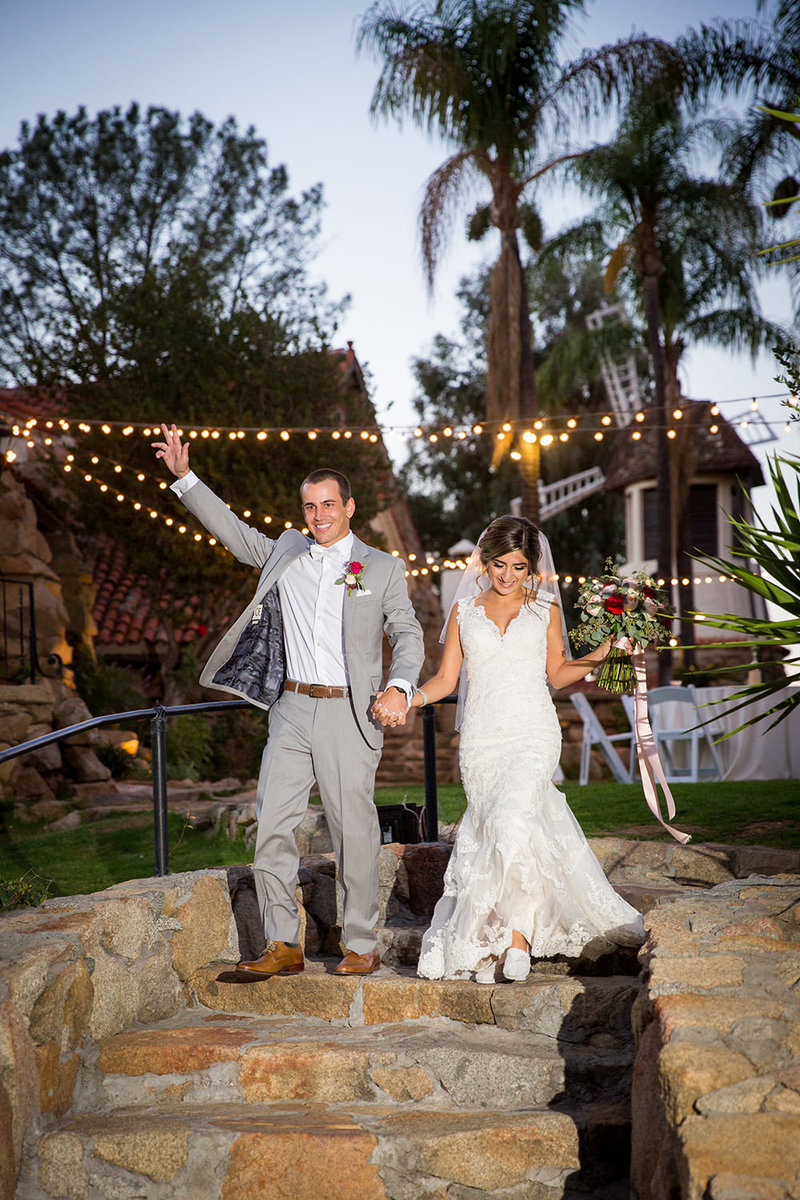bride and groom walking into reception