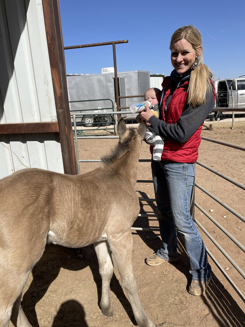 Dr. Taylor King and her new baby with a baby foal.